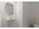 Bright powder room featuring a pedestal sink and neutral wall paint at 104 Big Cliff Ave, North Las Vegas, NV 89031