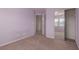 Secondary bedroom features carpet, mirrored closet and purple walls at 104 Big Cliff Ave, North Las Vegas, NV 89031