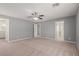 Large carpeted primary bedroom with ceiling fan, and multiple doorways at 104 Big Cliff Ave, North Las Vegas, NV 89031