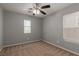Grey carpeted secondary bedroom with natural light and ceiling fan at 104 Big Cliff Ave, North Las Vegas, NV 89031