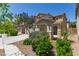 A beautiful two-story home with a two car garage, landscaped yard, and walkway at 104 Big Cliff Ave, North Las Vegas, NV 89031