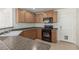 Kitchen featuring oak cabinets, laminate countertops, and black appliances at 104 Big Cliff Ave, North Las Vegas, NV 89031
