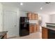Efficient kitchen with oak cabinets, laminate countertops, white walls and black appliances at 104 Big Cliff Ave, North Las Vegas, NV 89031
