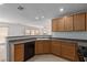 Bright kitchen featuring oak cabinets, laminate countertops, and updated appliances at 104 Big Cliff Ave, North Las Vegas, NV 89031