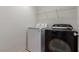 Laundry room featuring a white washing machine and a dark grey clothes dryer with an overhead wire shelf at 104 Big Cliff Ave, North Las Vegas, NV 89031