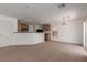 Living room showing access to the kitchen, a sliding door, carpet, and lots of light at 104 Big Cliff Ave, North Las Vegas, NV 89031