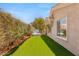 An inviting backyard featuring artificial turf, a well-maintained garden, and a relaxing hot tub at 10404 Long Leaf Pl, Las Vegas, NV 89134