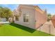 Backyard with a well-maintained turf, hot tub and exterior view of the home at 10404 Long Leaf Pl, Las Vegas, NV 89134