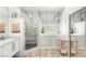 Bright bathroom featuring a walk-in shower and walk-in tub, marble walls and modern fixtures at 10404 Long Leaf Pl, Las Vegas, NV 89134