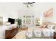 Bright bedroom with large bay windows, hardwood floors, a ceiling fan, and neutral decor at 10404 Long Leaf Pl, Las Vegas, NV 89134
