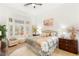 Bright bedroom with large bay windows, hardwood floors, a ceiling fan, and neutral decor at 10404 Long Leaf Pl, Las Vegas, NV 89134
