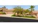 Charming single-story home with a well-manicured lawn and mature trees enhancing its curb appeal at 10404 Long Leaf Pl, Las Vegas, NV 89134
