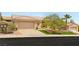 Charming single-story home with a well-manicured lawn and mature trees enhancing its curb appeal at 10404 Long Leaf Pl, Las Vegas, NV 89134
