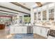 Spacious kitchen with marble countertops, stainless steel appliances, white cabinetry, and access to open living spaces at 10404 Long Leaf Pl, Las Vegas, NV 89134