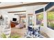 Open kitchen with bar seating flows into a living area with backyard access and views at 10404 Long Leaf Pl, Las Vegas, NV 89134