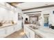 Open kitchen featuring marble countertops, stainless steel appliances, white cabinetry, and access to living spaces at 10404 Long Leaf Pl, Las Vegas, NV 89134