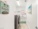 Well-lit laundry room with modern washer and dryer, sink, and storage at 10404 Long Leaf Pl, Las Vegas, NV 89134