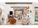 Bright living room with hardwood floors flows into outdoor patio via wall of windows at 10404 Long Leaf Pl, Las Vegas, NV 89134