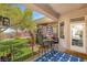 Covered patio seating area with a table set and a decorative anchor-themed rug at 10404 Long Leaf Pl, Las Vegas, NV 89134