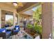 Cozy covered patio with comfortable seating, decorative pillows, and an umbrella table set at 10404 Long Leaf Pl, Las Vegas, NV 89134