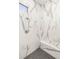 Close-up of shower area with gray and white marble tiles, with a built-in bench at 10404 Long Leaf Pl, Las Vegas, NV 89134