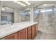 Bathroom featuring double sink vanity with stone countertops and glass shower at 10845 Drake Ridge Ave, Las Vegas, NV 89166