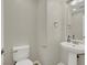 Modern powder room features a pedestal sink, updated fixtures, and a toilet at 10845 Drake Ridge Ave, Las Vegas, NV 89166