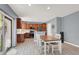 Dining area adjacent to the kitchen with wood-look floors and sliding glass doors to the backyard at 10845 Drake Ridge Ave, Las Vegas, NV 89166