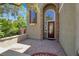 Inviting front porch with brick flooring and a decorative front door with sidelight windows at 10845 Drake Ridge Ave, Las Vegas, NV 89166