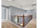 Second story hallway with decorative railing overlooking the entryway and first floor at 10845 Drake Ridge Ave, Las Vegas, NV 89166