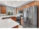 Updated kitchen features stainless steel appliances, wood cabinets, tile backsplash, and white quartz countertops at 10845 Drake Ridge Ave, Las Vegas, NV 89166