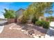 Landscaped side yard with stone pathway and mature trees adding to the curb appeal at 10845 Drake Ridge Ave, Las Vegas, NV 89166