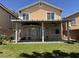This home's backyard has a covered patio, lawn, block wall, and lush greenery at 11029 Meadow Leaf Ave, Las Vegas, NV 89144