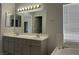 Bathroom with double sink vanity, large mirror and a soaking tub with a window at 11029 Meadow Leaf Ave, Las Vegas, NV 89144