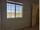 Bedroom showcasing wood floors, a window view, and a door at 11029 Meadow Leaf Ave, Las Vegas, NV 89144