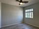 Bright, open bedroom showcasing sleek wood floors, a ceiling fan, and natural lighting at 11029 Meadow Leaf Ave, Las Vegas, NV 89144