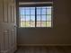 Bright bedroom features wood-look floors and a window view of neighboring homes at 11029 Meadow Leaf Ave, Las Vegas, NV 89144