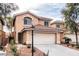 Two story home showcasing desert landscaping, a red tile roof, and a two car garage at 11029 Meadow Leaf Ave, Las Vegas, NV 89144