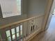Hallway landing area with hardwood floors, white railing and natural light at 11029 Meadow Leaf Ave, Las Vegas, NV 89144