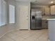 Kitchen with stainless steel refrigerator and tile floors at 11029 Meadow Leaf Ave, Las Vegas, NV 89144