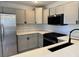 Well-lit kitchen featuring stainless steel appliances, gray cabinets and light countertops at 11029 Meadow Leaf Ave, Las Vegas, NV 89144