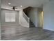 Living room featuring laminate flooring, a ceiling fan, and a staircase at 11029 Meadow Leaf Ave, Las Vegas, NV 89144