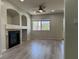 Living room with a fireplace, ceiling fan, and laminate flooring at 11029 Meadow Leaf Ave, Las Vegas, NV 89144