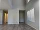 Spacious living room featuring gray hardwood floors, natural light, and high ceilings at 11029 Meadow Leaf Ave, Las Vegas, NV 89144
