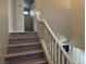 Staircase with wood-look flooring and a white railing leading to the upper level at 11029 Meadow Leaf Ave, Las Vegas, NV 89144