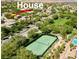 Aerial view of a lush community with a tennis court, pool, and beautiful landscaping at 11074 Caramel Crest Ct, Las Vegas, NV 89135