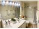 Stylishly updated bathroom with double sinks, marble tile shower, and modern fixtures at 11074 Caramel Crest Ct, Las Vegas, NV 89135