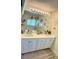 Bathroom with double sink vanity, large mirror, and modern lighting at 11074 Caramel Crest Ct, Las Vegas, NV 89135