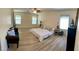 Large open bedroom with wood-look floors, lots of windows for natural light and comfortable seating at 11074 Caramel Crest Ct, Las Vegas, NV 89135