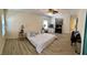 Open bedroom with wood-look floors, ceiling fan, lots of natural light and a seating area at 11074 Caramel Crest Ct, Las Vegas, NV 89135